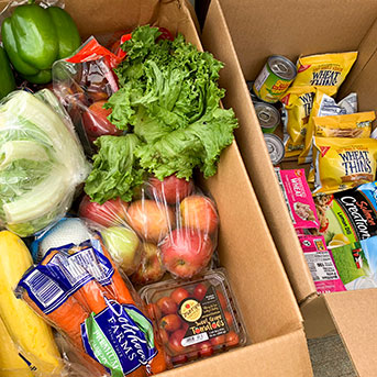 Vegetables and bags of food in a box. Links to Gifts That Pay You Income